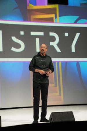 Picture of Jeff Charney on stage speaking at an industry conference.